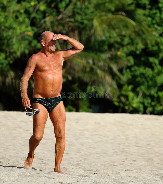 bronzed-man-beach-elderly-swimming-trunks-suntan-looks-out-to-sea-bali-83070753.jpg
